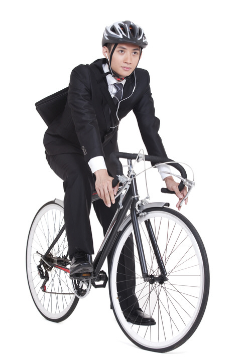 young businessman riding a bike